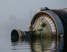 a large propeller sitting on top of a body of water