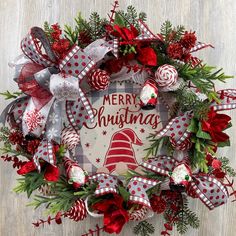 a christmas wreath with red, white and green decorations