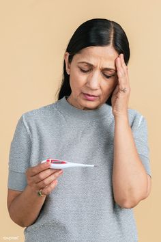 Indian woman with a headache measuring her temperature with an electric thermometer  | premium image by rawpixel.com / McKinsey Fever Images, Viral Fever, Person Photo, Indian Men, Nerve Pain Relief, Strengthening Exercises, Man Images