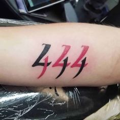 a person with a tattoo on their arm has the number 424 written in red ink