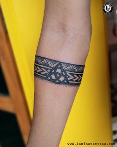 a tattoo on the arm of a person with a black lace around it's wrist