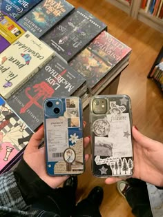 two people holding up their cell phones in front of books