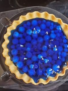 a pie with blue balls in it sitting on top of a stove