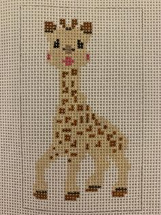 a cross - stitch giraffe is shown on a white background with brown dots