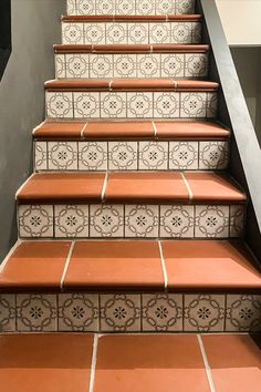 an orange and white tiled stair case