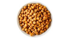 a white bowl filled with chickpeas on top of a white table next to a fork