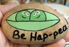 a hand painted rock with two peas on it that says be hop - peo