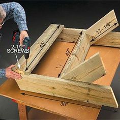 a man using a drill to attach the sides of a wooden box with two screwdrivers