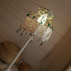 a lamp that is sitting on top of a table next to baskets and other items