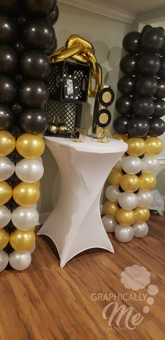 black and gold balloons are on the table