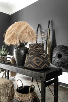 a black table topped with vases and baskets