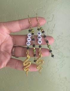 Check out these fun, hand wired and beaded Taylor earrings! These earrings feature different Taylor lyrics, songs, or eras! I have spent time compiling ideas from Swifties, but I'm also open to taking custom orders for these earrings! Just keep in mind, the longer the word, the longer the dangle of the earring. The average dangle is about 3 inches on these earrings. Colors of seed beads and alphabet letters may vary. Finish choices for the hooks are sterling silver and gold plated, both are hypo Letter Bead Earrings, Dangle Beaded Earrings, Taylor Lyrics, Letter Earrings, Letter Beads, Alphabet Letters, Bead Earrings, Beaded Dangles, Beaded Earrings