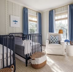 a baby's room with blue and white decor, including a crib in the corner