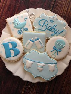 baby shower cookies are arranged on a plate