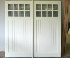 two white doors are open in a room