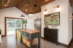 a kitchen with an island in the middle and lots of counter space next to it