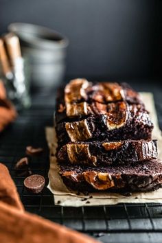 chocolate espresso banana bread on a cooling rack with cinnamon in the foreground