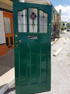 a green door with stained glass on it