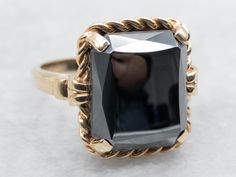 This lovely ring is crafted of polished yellow gold, with four prongs holding the stone securely. The center is a faceted, perfectly polished rectangle of Hematite, a highly reflective dove-gray stone with plenty of shine! Hematite is said to ground the energies of the wearer, preventing stress or worry. Metal: 10K Yellow Gold Gem: Hematite 10.50 Carats Gem Measurements: 12.0 x 14.1 mm, Rectangle Ring Size: 6.25 Marks: "10K{R/S}" Stamped on the inside band SKU #: A50345 Each piece has been identified and graded by a Graduate Gemologist who has been certified by the Gemological Institute of America (GIA). We have six brick-and-mortar storefronts in Maine, Massachusetts and New Hampshire and have been in business for over 25 years! Please visit our Shop's About Page or our website for more i Hematite Jewelry, Rectangle Ring, Hematite Ring, Lovely Ring, Grey Stone, Ring Vintage, Yellow Gold Rings, New Hampshire, Solitaire Ring