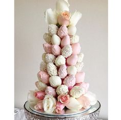 a cake with pink and white flowers on it's top is featured in the instagram