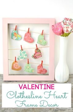 valentine's day craft with clothesline hearts hanging on a clothes line in front of a vase