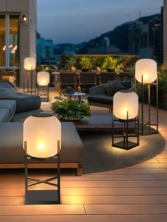 a living room filled with lots of furniture and lamps on top of wooden flooring