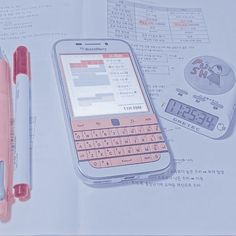 a cell phone sitting on top of a book next to a pen and calculator