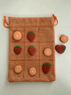 oranges and strawberries are arranged on a cloth