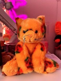 an orange stuffed animal sitting on top of a table