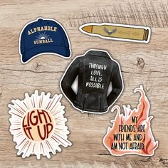 several stickers on a wooden surface including a baseball cap, fire extinguisher's hat, and other items