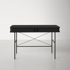 a black table with two drawers sitting on it's side, in front of a white wall