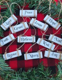 christmas decorations made out of wine corks and twine with words that read peace, hope, faith, jesus, and merry