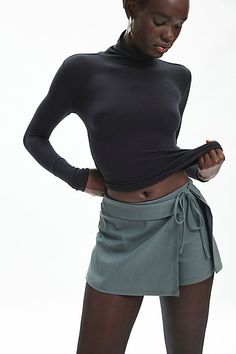 BDG skort in a wrap-front silhouette. Designed in a woven fabric with a touch of stretch featuring a mid-rise waistline, wrap-front overskirt with a tie detail at the waistline for a personalized fit. Find it only at Urban Outfitters. Features BDG Bengaline wrap tie-front micro skort Asymmetrical mini skort Stretch woven fabric Mid-rise waistline with tie detail Asymmetrical overskirt panel Shorts at the back Slim fit Mini length Adjustable tie detail Zip closure UO exclusive Content + Care 74% Trendy Skirts, Women's Bottoms, Jeans Pants, Woven Fabric, Womens Bottoms, Cool Style, Mid Rise, Urban Outfitters, Fitness Models