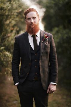 a man with a red beard wearing a suit and tie