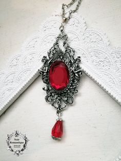 "Lucinda pendant Robert gave some of his blood to Lucinda for her to drink.\" Iris was perplexed by this . \"What for?\" she asked. \"To change her into one of us, into a vampire... A mesmerizing pendant holding a ruby red gem 18x25mm" Victorian Gothic Jewelry, Red Pendant Necklace, Vampire Necklace, Vampire Jewelry, Gothic Bracelet, Gothic Earrings, Red Pendants, Bronze Necklace, Gothic Accessories