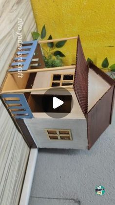 a doll house made out of cardboard sitting on the floor