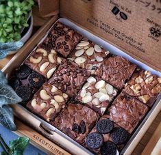 a box filled with brownies and cookies on top of a table