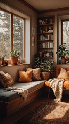 a living room filled with lots of furniture and plants on top of windowsills