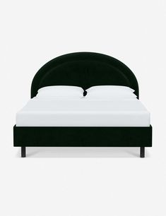 a bed with a black headboard and white sheets on it's sides, against a gray background