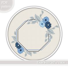 a cross stitch pattern with blue flowers and leaves on a white circular frame, in the shape of a hexagon