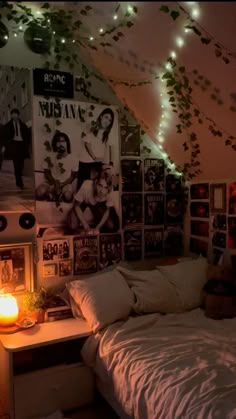 a bedroom with lights and posters on the wall