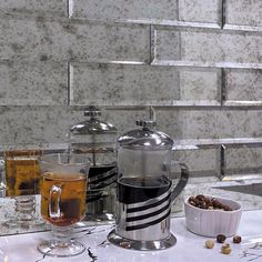 a table topped with two cups filled with liquid and nuts