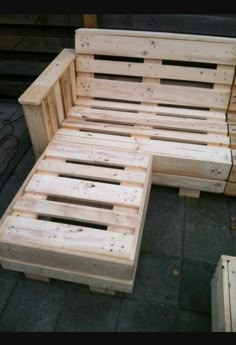 a couch made out of wooden pallets sitting on the ground