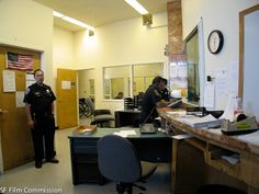 two police officers are standing in an office