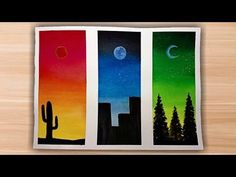 three different colored paintings with trees and the moon in the sky above them, on a wooden surface