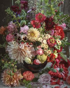 a vase filled with lots of different colored flowers