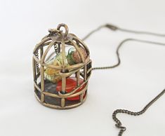 This is a beautiful vintage inspired birdcage pendant necklace.  Inside is a small green spell jar full of calendula. Calendula is for happiness and prosperity.  There is also a Carnelian tumble. Carnelian is amazing for creativity and confidence.  I only keep a few things in my etsy shop now. My full collection of art and antiques has been moved to my website. To see all of my collection you can find it here: https://www.wildflowermoonmagic.com/ Spell Jar Necklace, Dark Spells, Raven Skull Necklace, Vintage Candlestick Holders, Witch Necklace, Gold Candle Sticks, Carnelian Pendant, Carnelian Jewelry, Carnelian Necklace