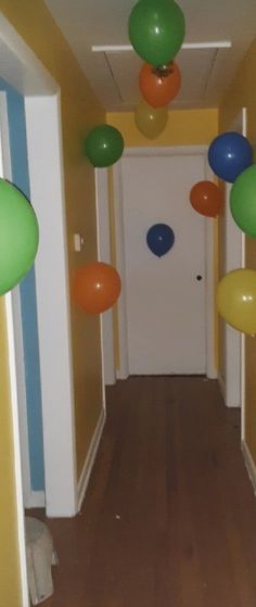 the hallway is decorated with balloons and streamers