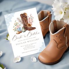 boots and flowers are on the bed next to a card