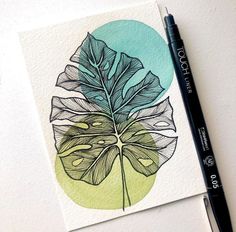 a drawing of a leaf on paper next to a black marker and green circle behind it